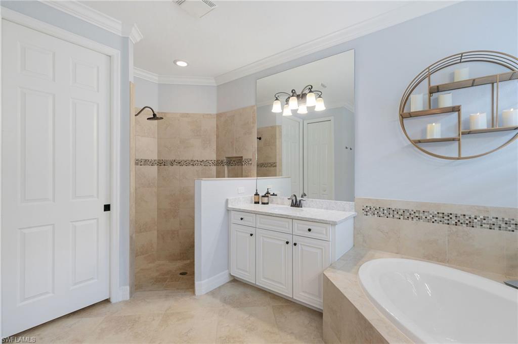 2862 Aviamar Circle Naples, FL 34114 - Photo 21 of 48 Bathroom with a garden tub, walk in shower, vanity, crown molding, and recessed lighting