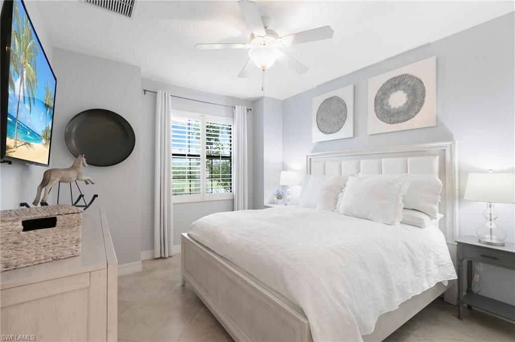 2862 Aviamar Circle Naples, FL 34114 - Photo 25 of 48 Bedroom featuring light tile patterned flooring and a ceiling fan