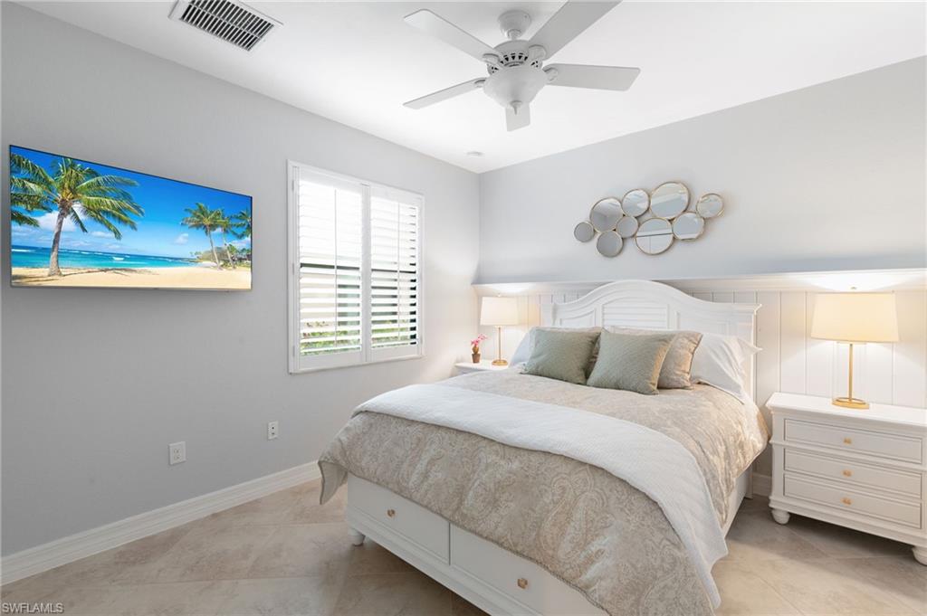 2862 Aviamar Circle Naples, FL 34114 - Photo 27 of 48 Bedroom with a ceiling fan and light tile patterned floors