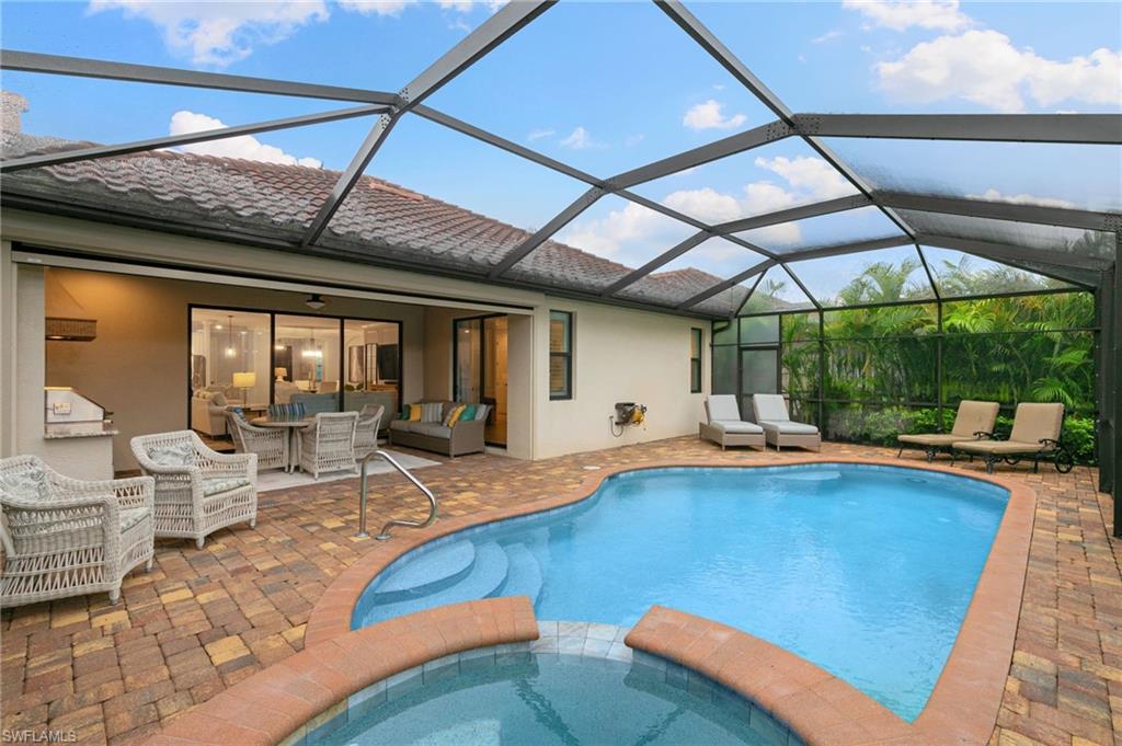 2862 Aviamar Circle Naples, FL 34114 - Photo 33 of 48 View of swimming pool with a sunroom, a lanai, a patio, and a pool with connected hot tub