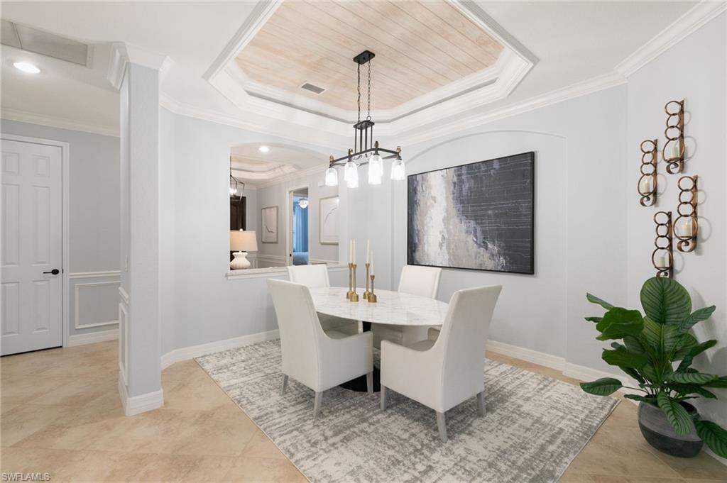 2862 Aviamar Circle Naples, FL 34114 - Photo 6 of 48 Dining space featuring a tray ceiling, crown molding, light tile patterned flooring, and recessed lighting