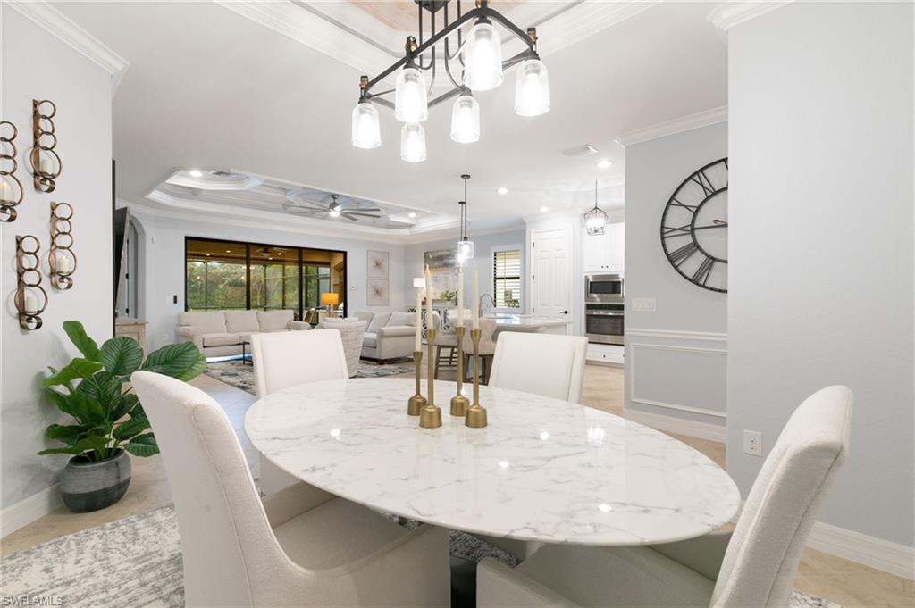 2862 Aviamar Circle Naples, FL 34114 - Photo 7 of 48 Dining space featuring crown molding, a raised ceiling, and ceiling fan