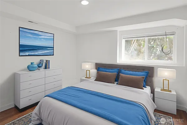 a bedroom with a bed and a window