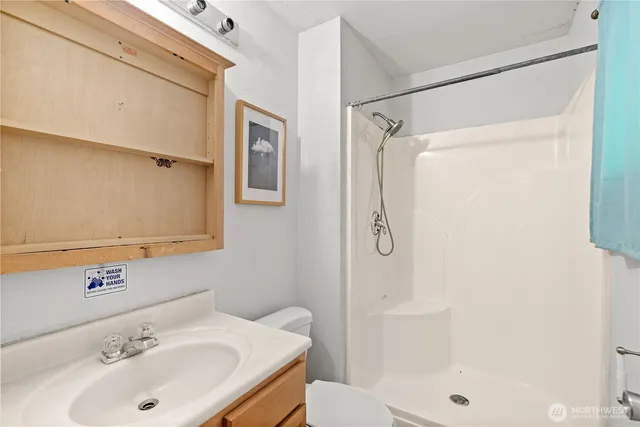 a bathroom with a sink toilet and shower