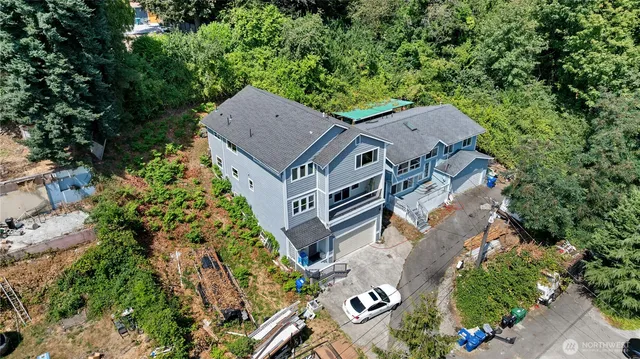 an aerial view of a house with a yard