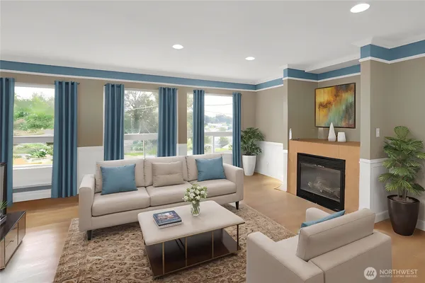 a living room with furniture a large window and a fireplace