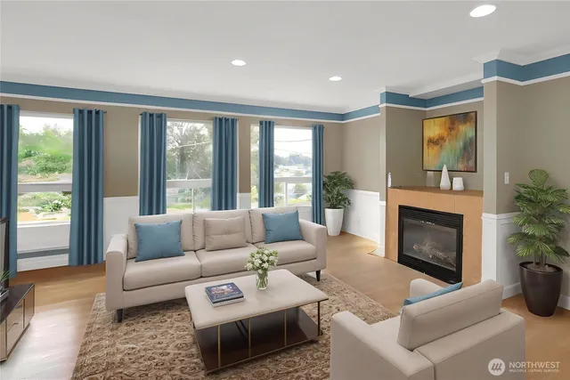 a living room with furniture a large window and a fireplace