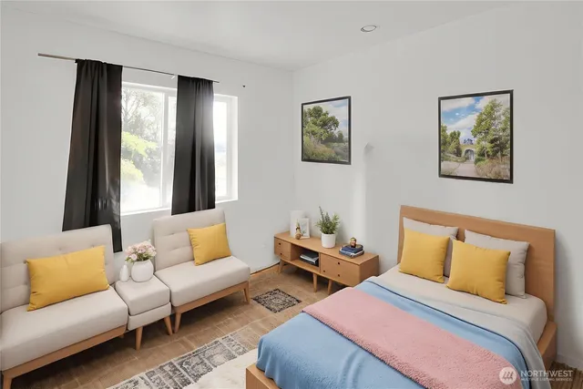 a bedroom with a bed couch and window