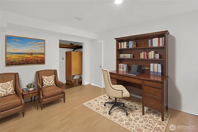 a view of a livingroom with workspace and a couch