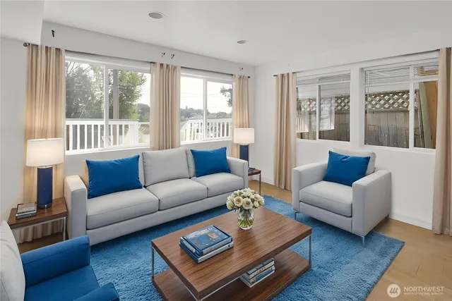 a living room with furniture a large window and a rug