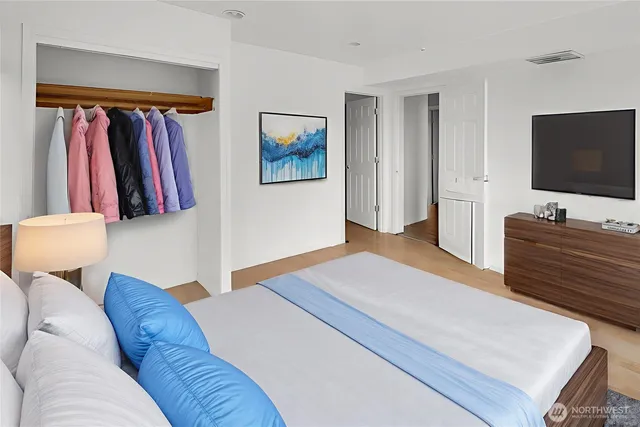 a bedroom with a bed and a flat screen tv