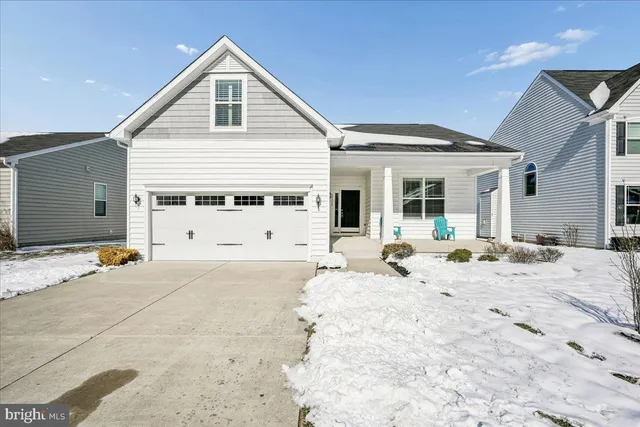 a view of a house with snow on the road