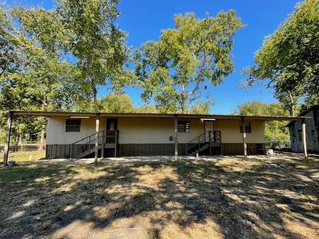 a backyard of a house with yard and garage