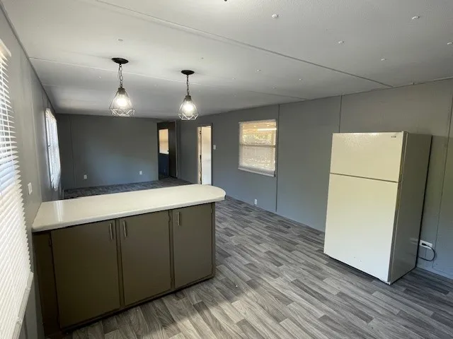 a kitchen with kitchen island a counter top space a sink and appliances