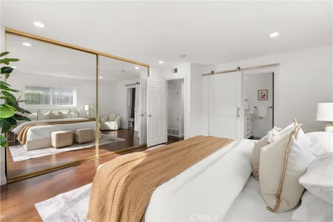 a bedroom with a bed and a couch