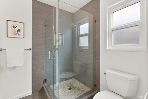 a bathroom with a toilet and a shower