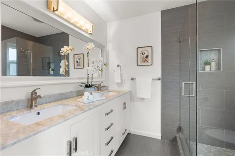 a bathroom with a double vanity sink and a mirror