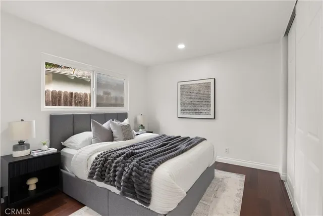 a bedroom with a large bed and a lamp