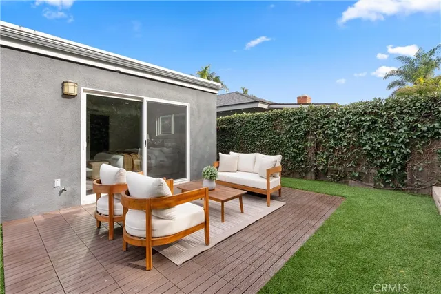a backyard of a house with table and chairs
