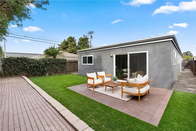 a backyard of a house with table and chairs