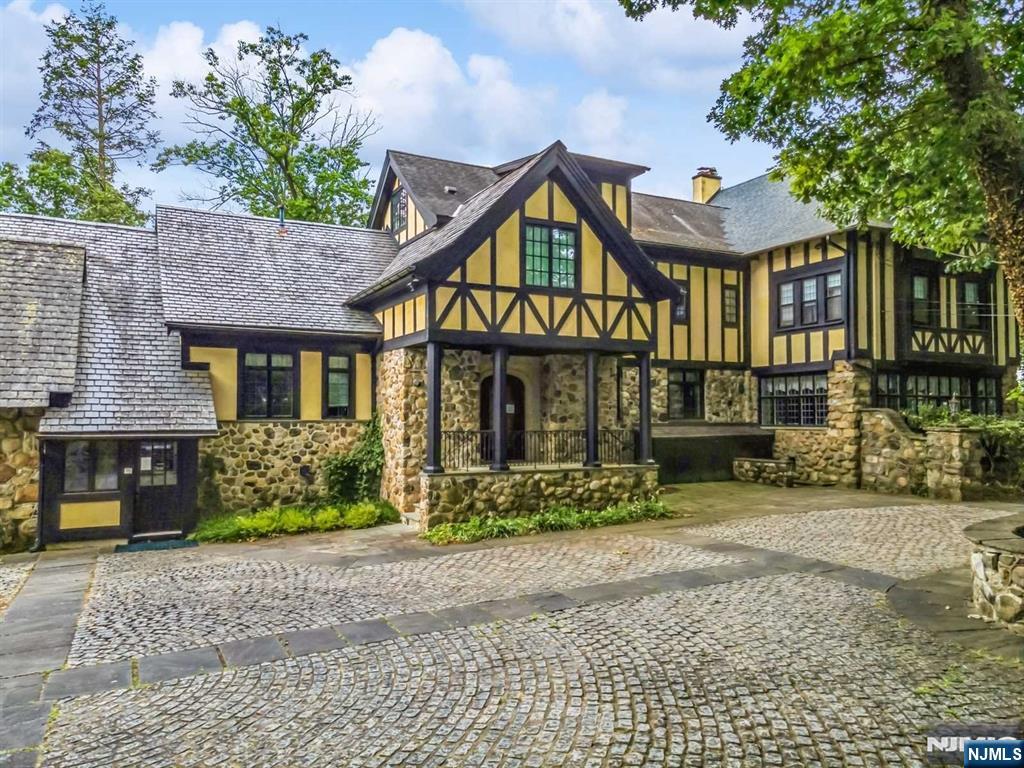 131 Rensselaer Road Essex Fells, NJ 07021 - Photo 11 of 48 a front view of a house with garden