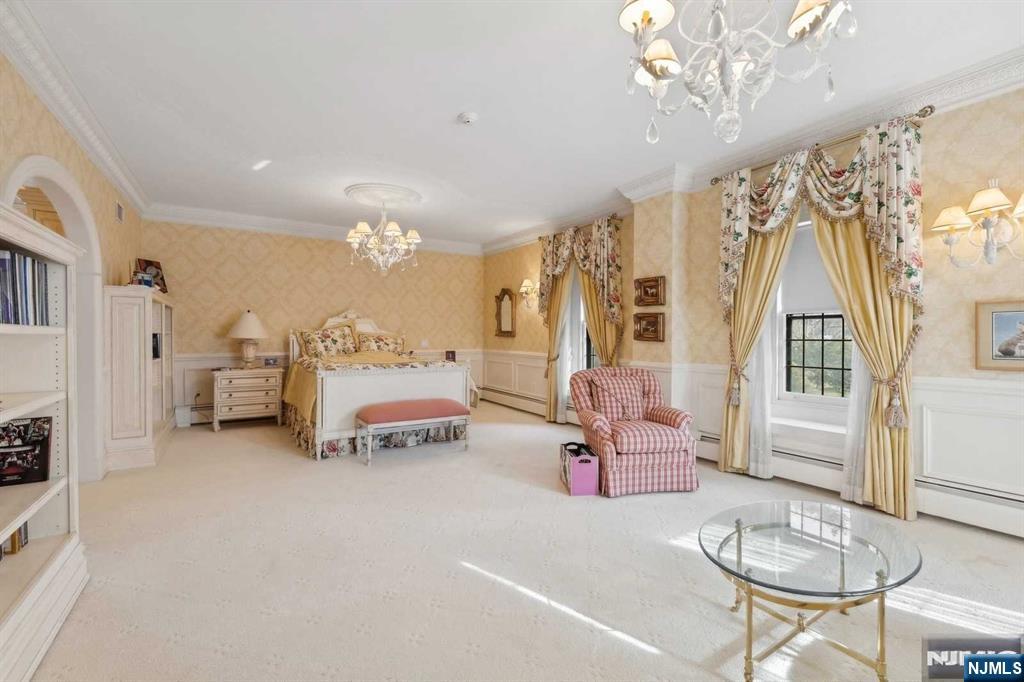 131 Rensselaer Road Essex Fells, NJ 07021 - Photo 31 of 48 a spacious bedroom with furniture and a chandelier