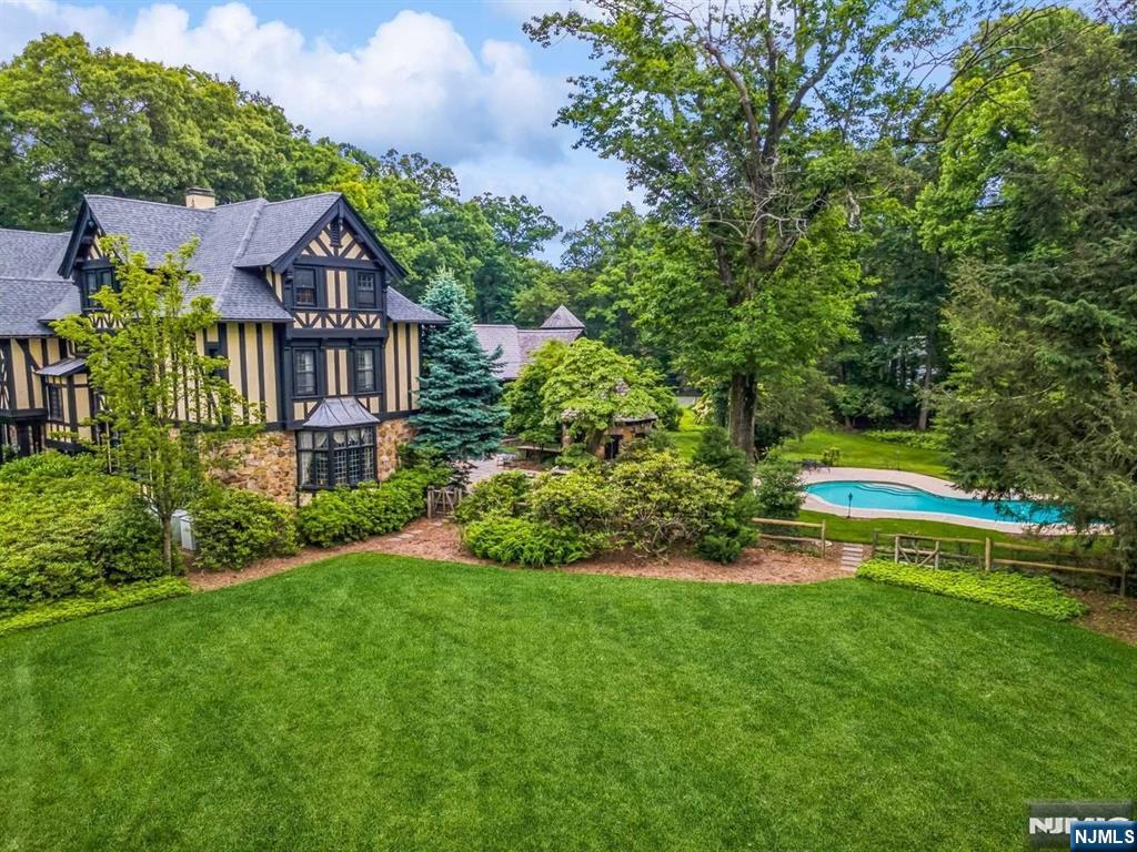 131 Rensselaer Road Essex Fells, NJ 07021 - Photo 4 of 48 a view of an house with a big yard and large trees