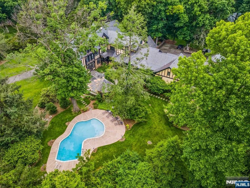 131 Rensselaer Road Essex Fells, NJ 07021 - Photo 7 of 48 an aerial view of a house with a yard and trees all around