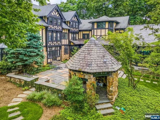 a aerial view of a house with swimming pool and sitting area