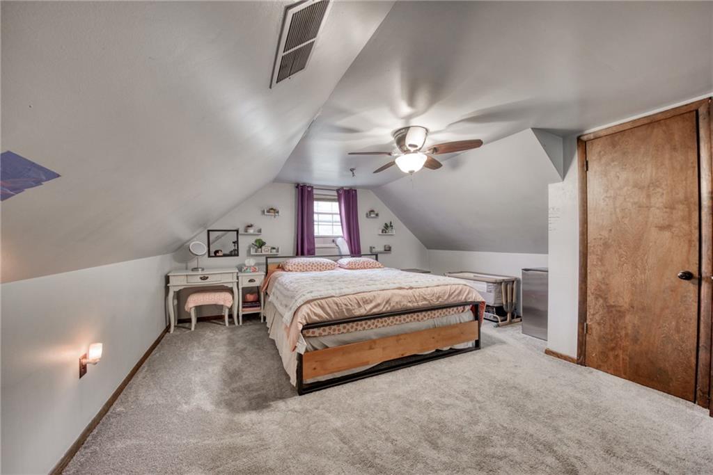 211 New York Avenue Rochester, PA 15074 - Photo 26 of 47 a spacious bedroom with a bed and a chandelier