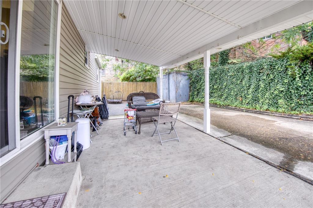 211 New York Avenue Rochester, PA 15074 - Photo 38 of 47 a view of a patio with table and chairs potted plants with floor to ceiling window
