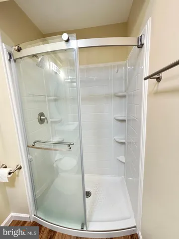 a bathroom with a glass shower door