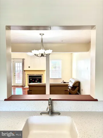 a living room with granite countertop furniture and chandelier