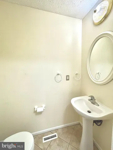 a bathroom with a sink a toilet and mirror