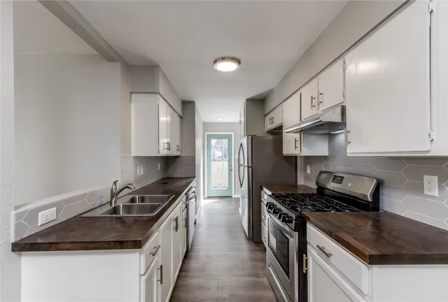 a kitchen that has a sink and a stove