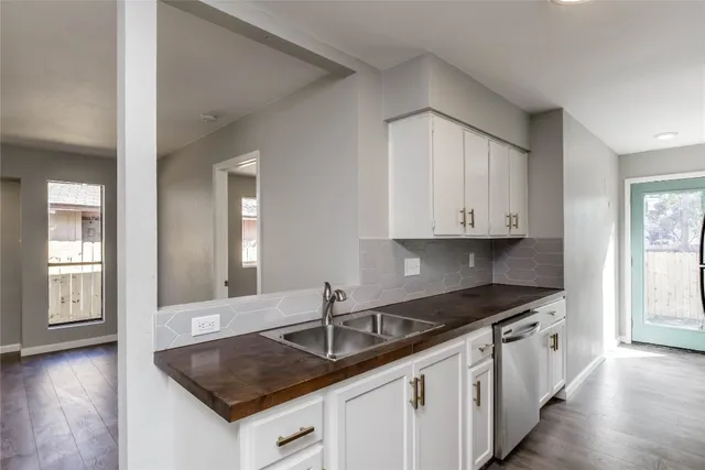 a kitchen that has a sink and a stove in it
