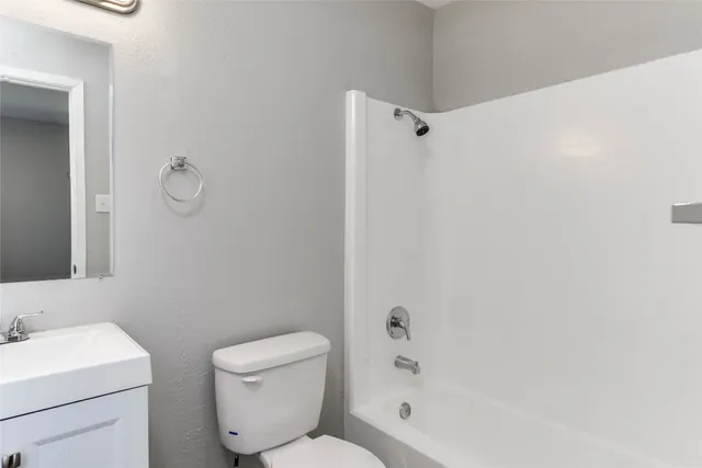 a bathroom with a toilet sink and shower