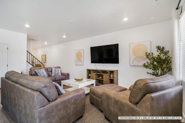 1702 Ripple Rock Drive, Unit 3171 Washington, UT 84780 - Photo 6 of 16 Open-concept living area featuring recessed lighting, light wood-finish flooring, white walls, and a staircase with dark railings