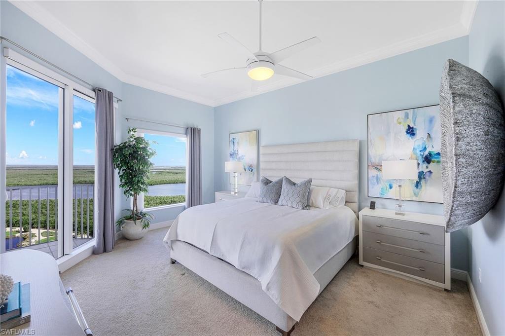 1060 Borghese Lane, Unit 2002 Naples, FL 34114 - Photo 11 of 22 a bedroom with a large bed and a large window