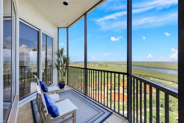 a living room with furniture and a floor to ceiling window