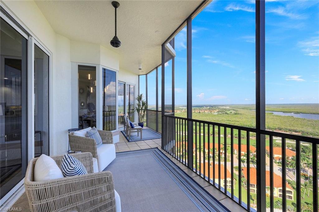 1060 Borghese Lane, Unit 2002 Naples, FL 34114 - Photo 19 of 22 a living room with furniture and a floor to ceiling window