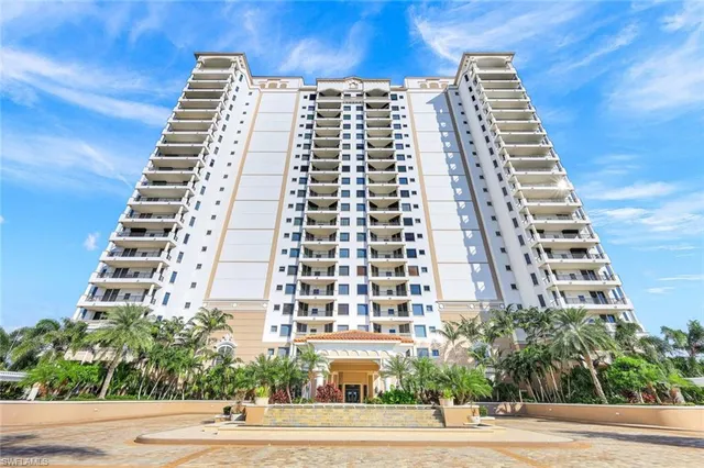a living room with fireplace furniture and a large window