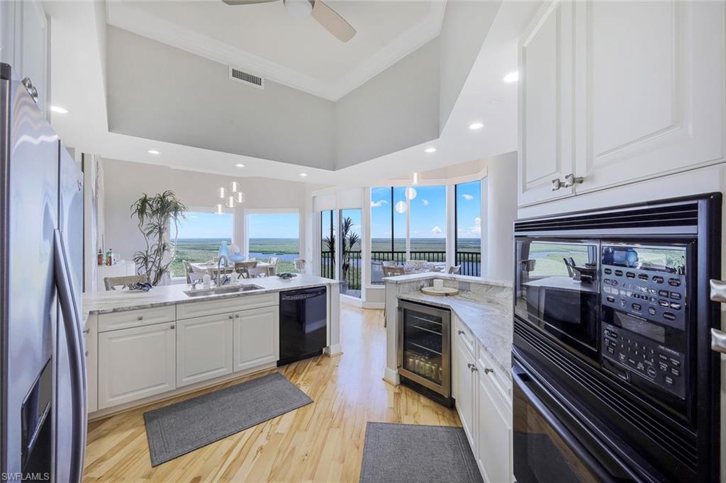 1060 Borghese Lane, Unit 2002 Naples, FL 34114 - Photo 7 of 22 a kitchen with a stove and a sink