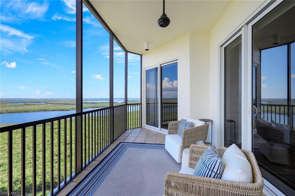 1060 Borghese Lane, Unit 2002 Naples, FL 34114 - Photo 10 of 22 a balcony with furniture and a potted plant