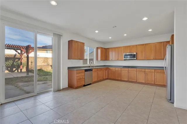 a large kitchen with a large counter top and outdoor space