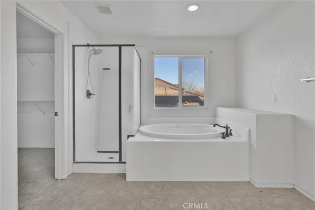 a bathroom with a tub and a shower