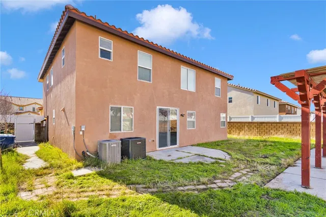a backyard of a house with table and chairs