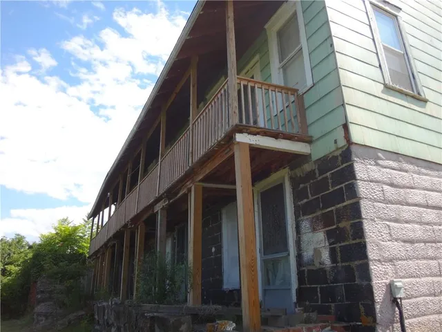 a view of a house with a yard and garage