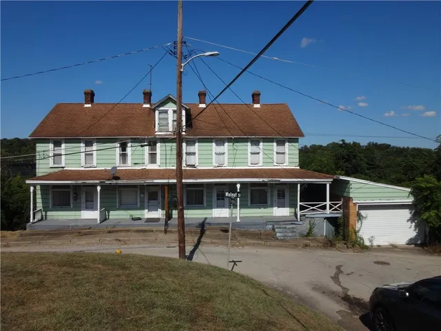a patio with a table and chairs under an umbrella