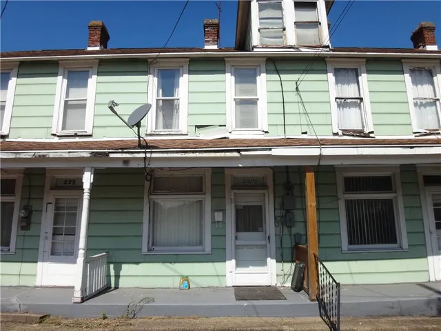 a view of brick house with large windows